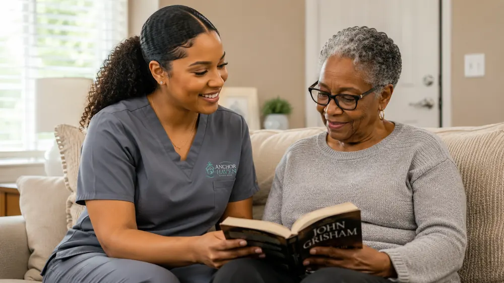 A caregiver and an older woman reading a book together, heads bent over the same page.